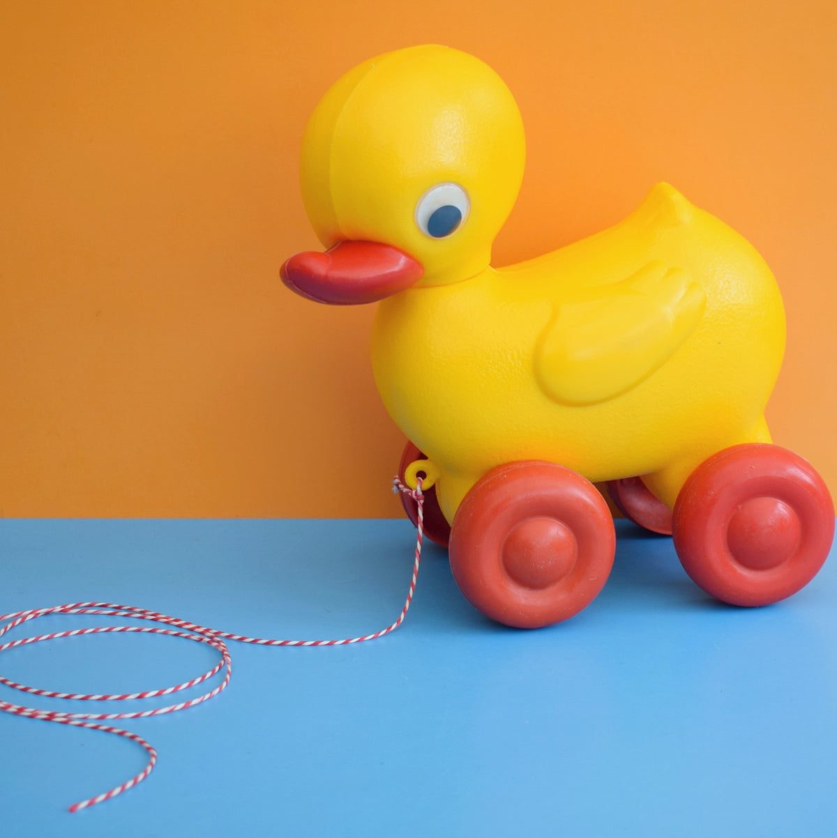 Vintage 1980s Plastic Yellow Duck With Red Wheels