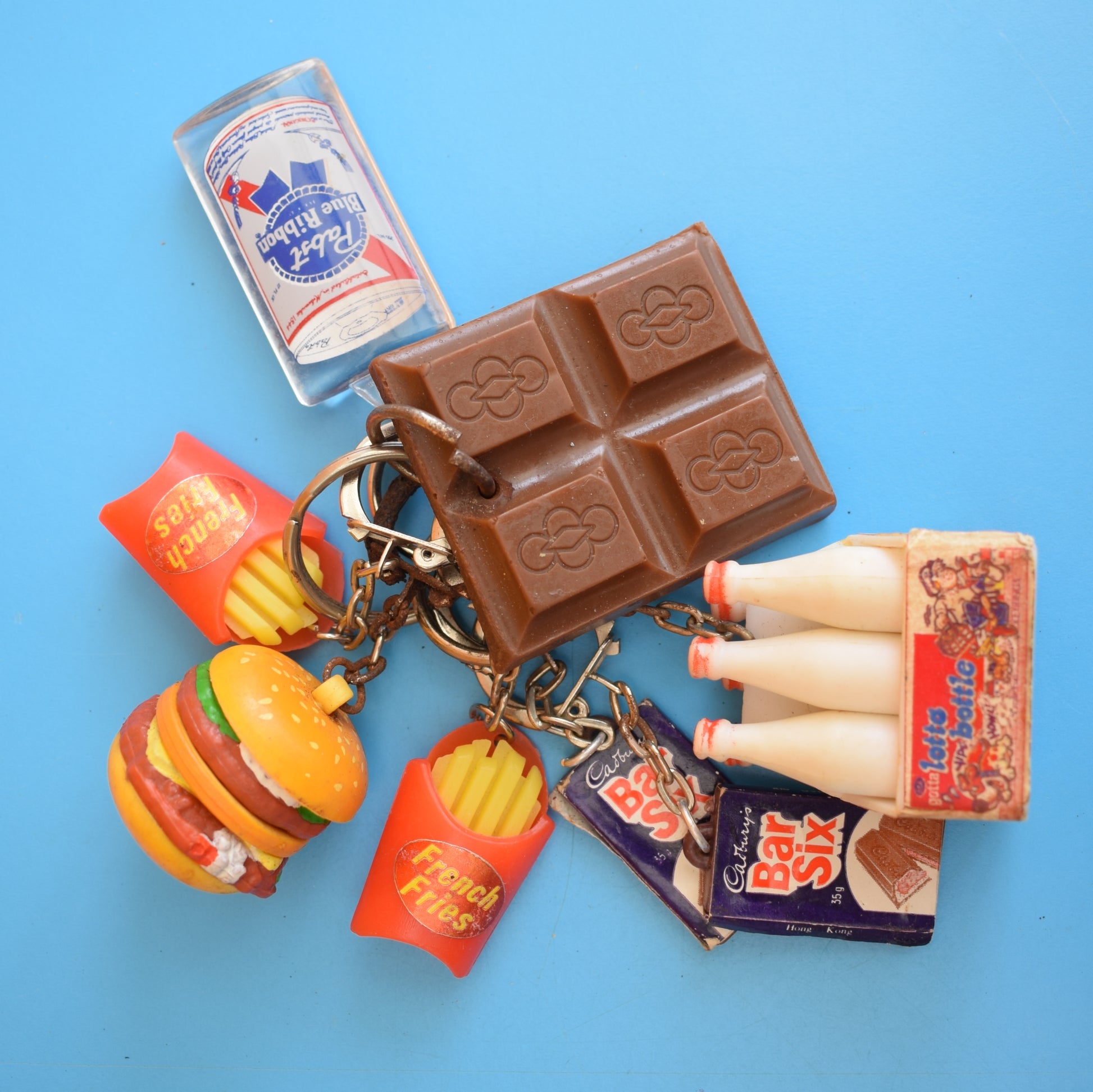 Vintage 1980s Mixed Keyrings - PacMan, Miniatures Etc by Pineapple Retro